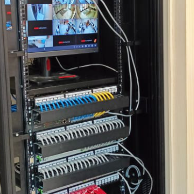 Network rack with patch panels and a CCTV monitor in the L7 Group data center