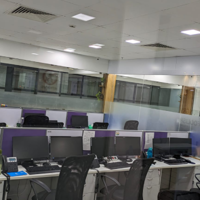 Open-plan office workstations with desktop monitors at an L7 Group office