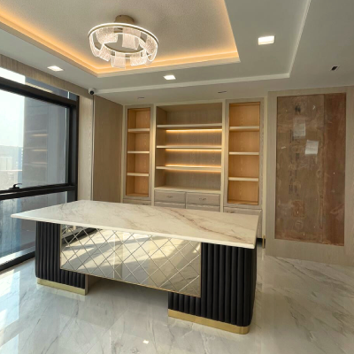 Executive cabin with marble-top desk and lit shelving at the new L7 Group office