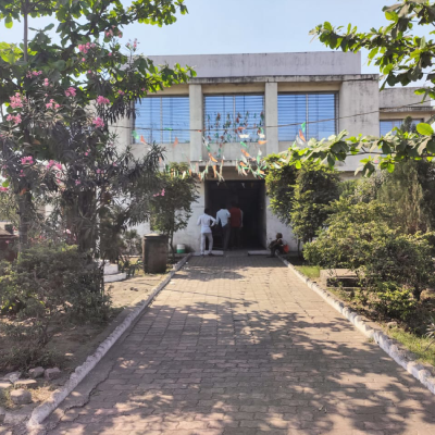 Building entrance with paved garden path at a FASTag project site (L7 Group)